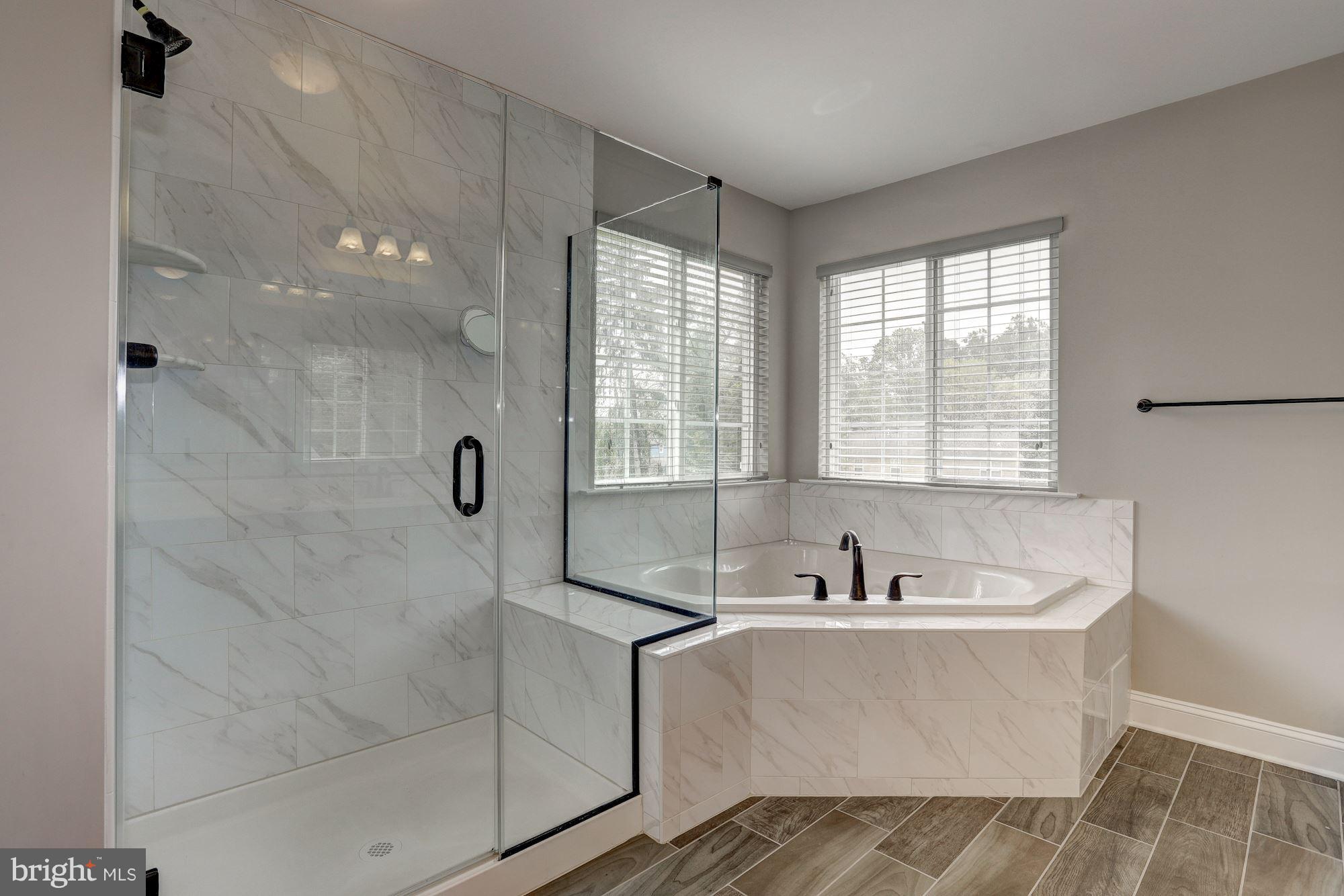 8420 High Ridge Road Ellicott City, MD 21043 - Photo 16 of 30 a bathroom with a bathtub and a sink
