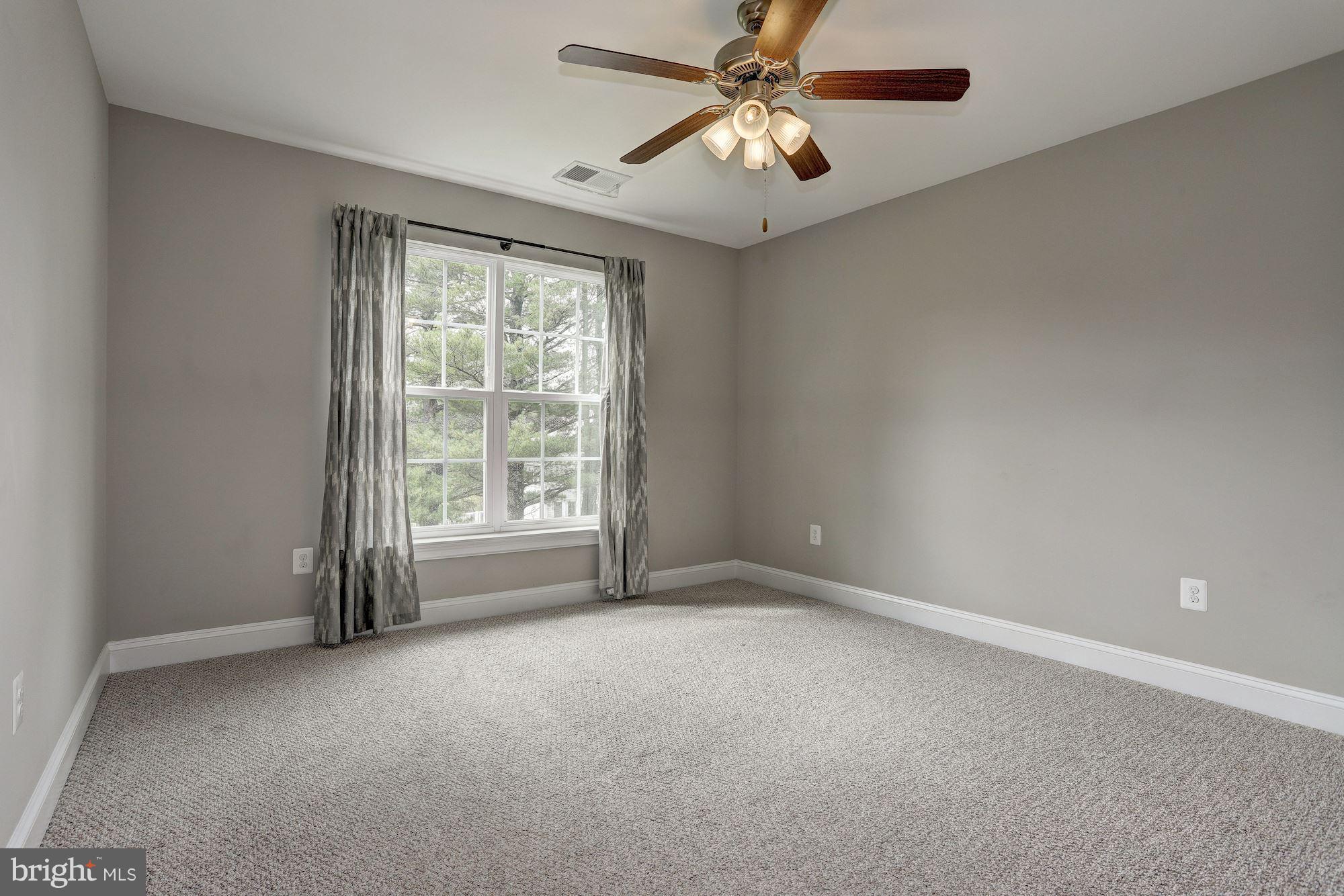 8420 High Ridge Road Ellicott City, MD 21043 - Photo 17 of 30 an empty room with windows and fan