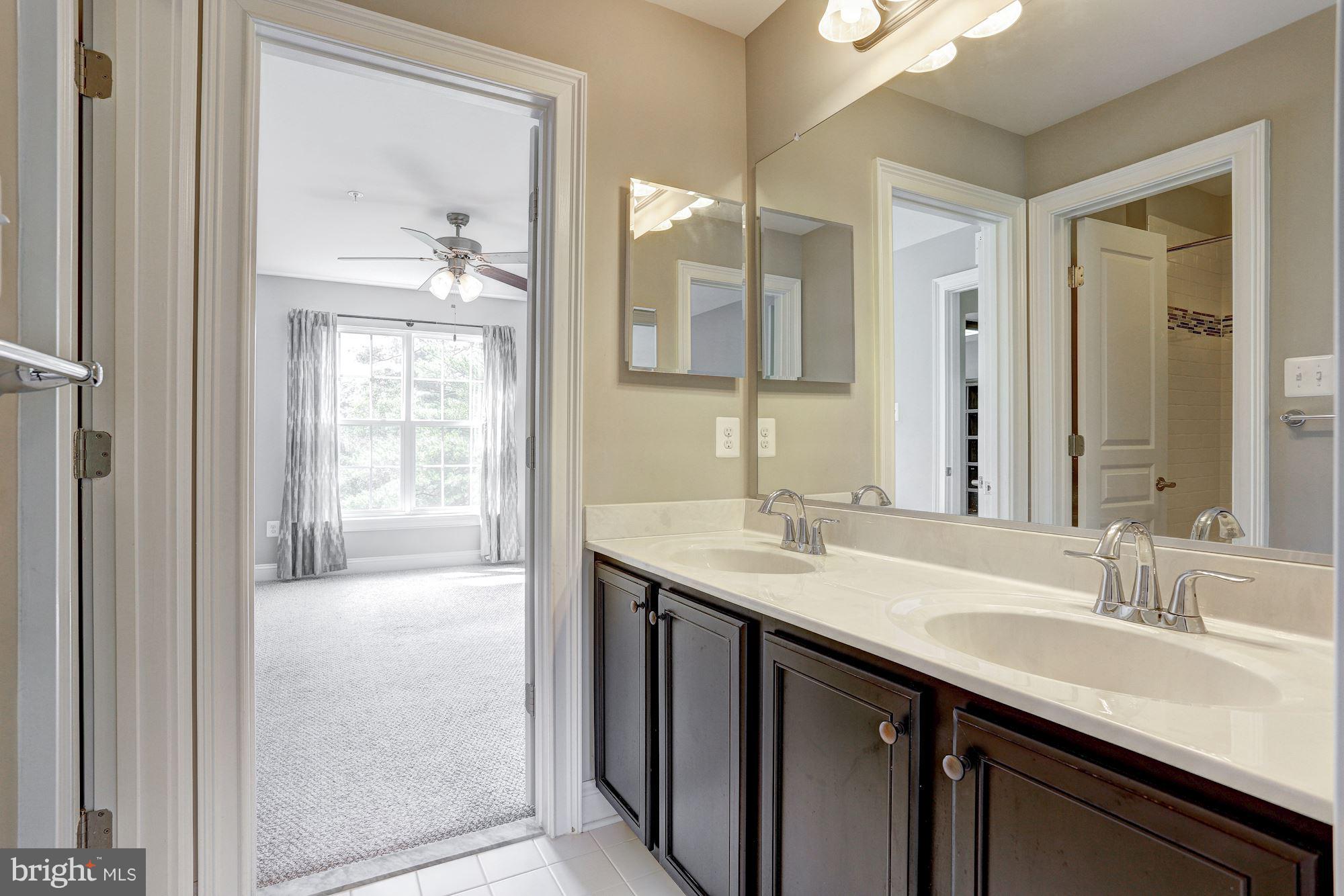 8420 High Ridge Road Ellicott City, MD 21043 - Photo 18 of 30 a bathroom with a sink double vanity and a mirror