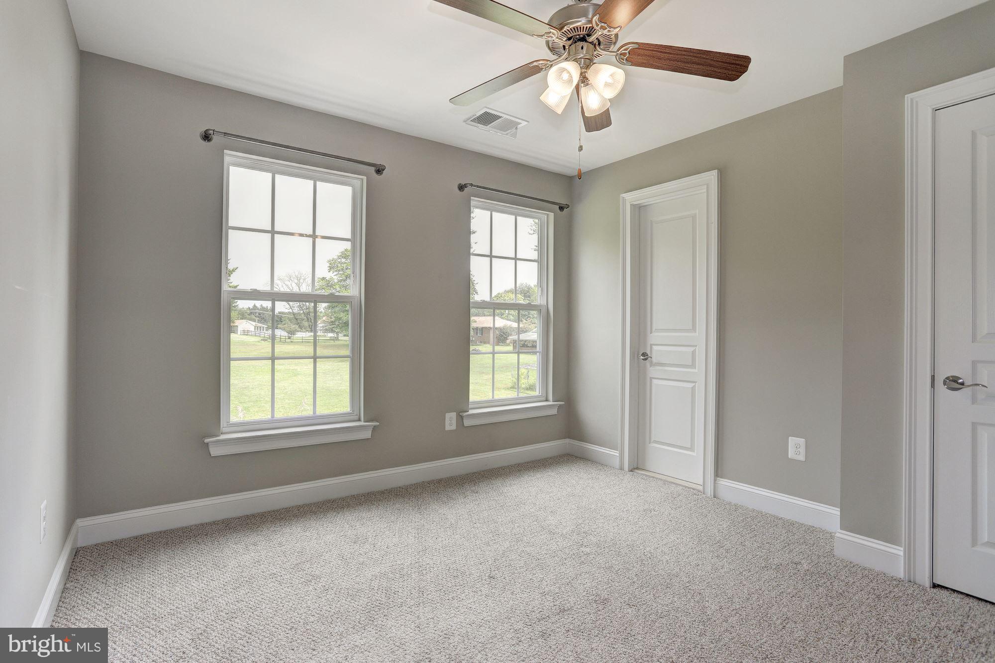 8420 High Ridge Road Ellicott City, MD 21043 - Photo 20 of 30 an empty room with windows and fan
