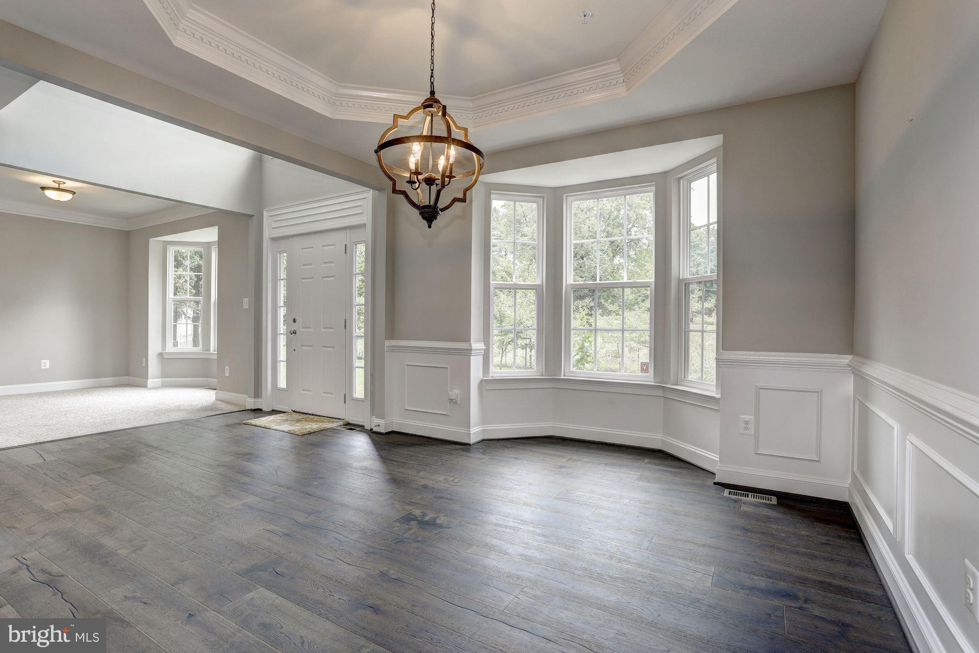 8420 High Ridge Road Ellicott City, MD 21043 - Photo 4 of 30 a view of an empty room with wooden floor and windows