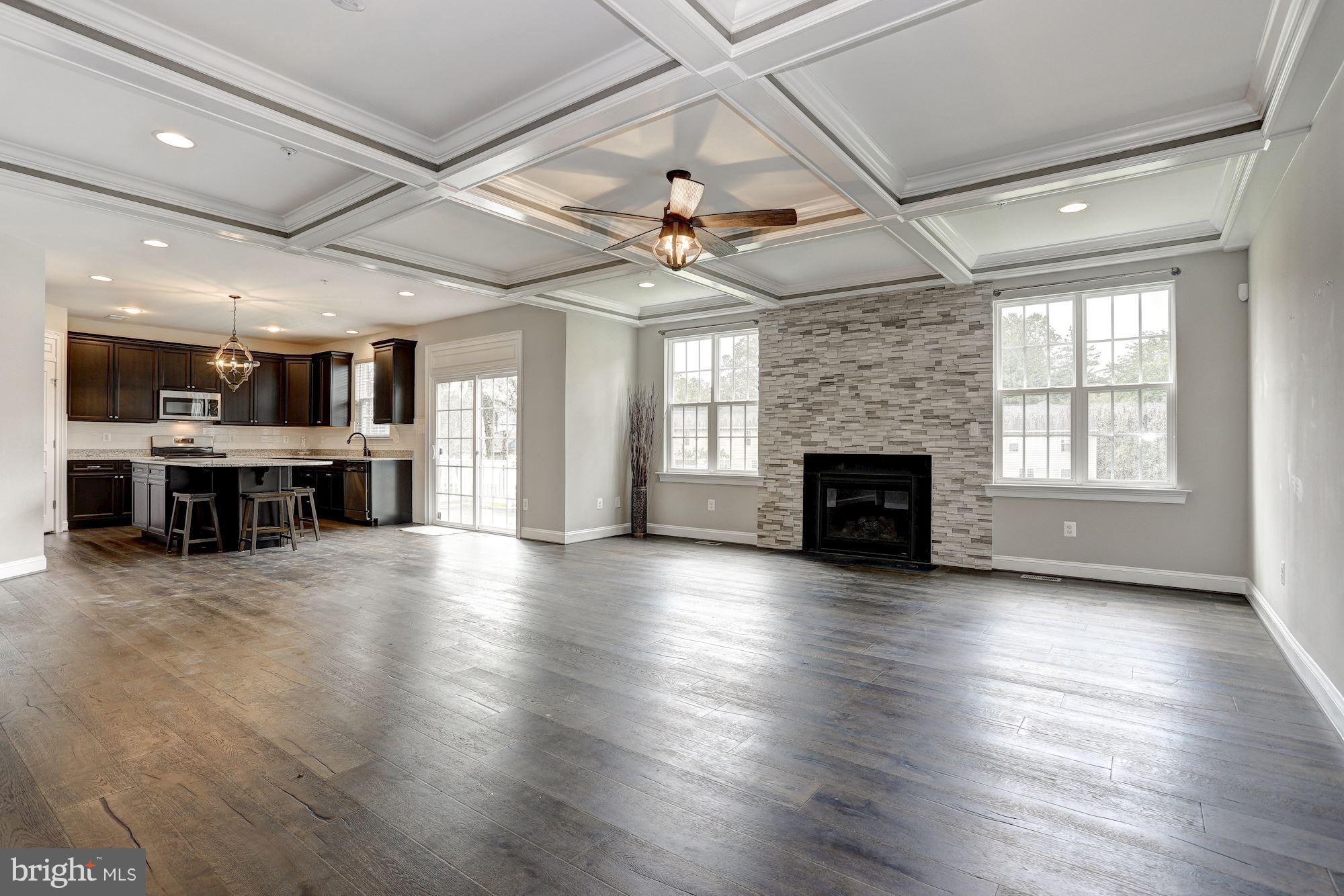 8420 High Ridge Road Ellicott City, MD 21043 - Photo 7 of 30 an empty room with wooden floor fireplace and windows