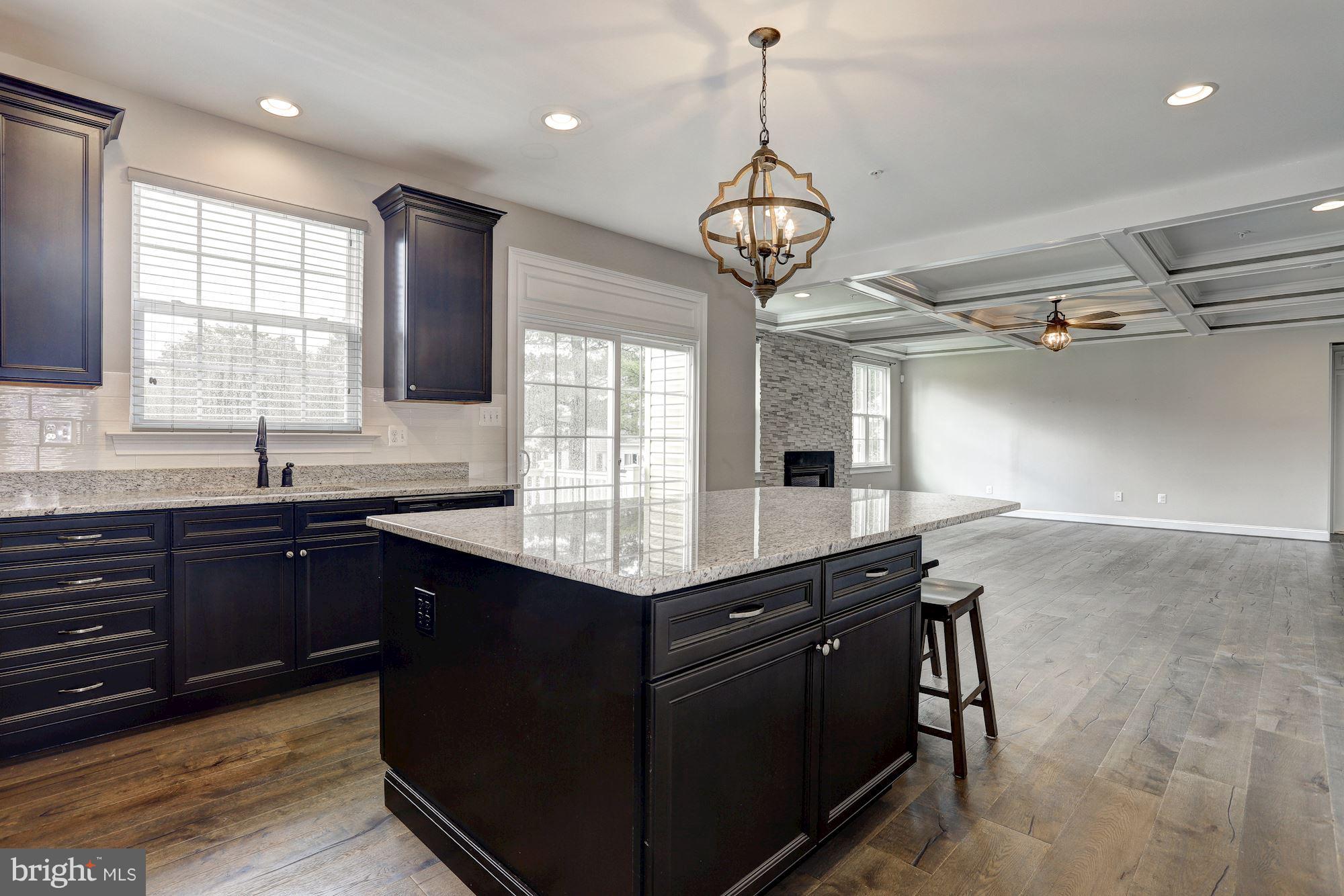 8420 High Ridge Road Ellicott City, MD 21043 - Photo 10 of 30 a kitchen with a counter space a sink and cabinets