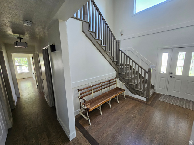 812 East Bates Cyn Road Tooele, UT 84074 - Photo 10 of 144 Two-story foyer featuring wood-finish flooring, a grand staircase with painted banister and newel post, and wainscoting