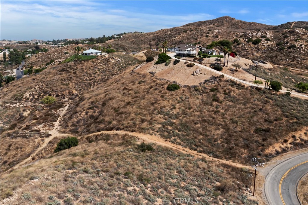 an aerial view of house with yard and mountain view in back
