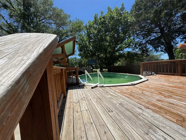 a view of a backyard with wooden floor
