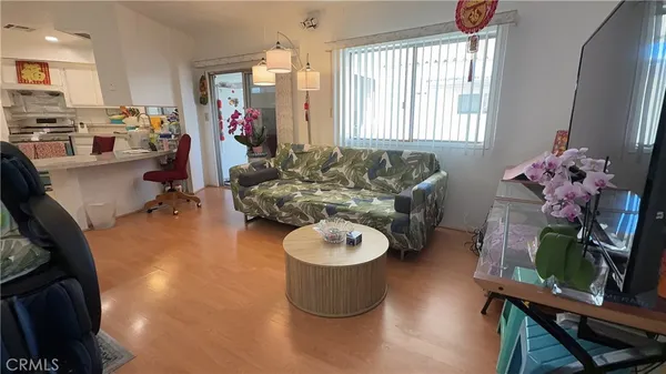 a living room with furniture and a floor to ceiling window