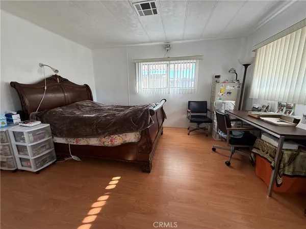 a bedroom with bed and window