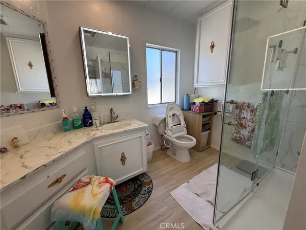 a bathroom with a sink mirror and toilet