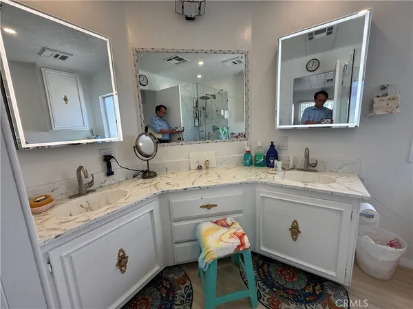 a view of bathroom with dual sinks