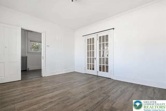 a bathroom with a toilet sink vanity and mirror