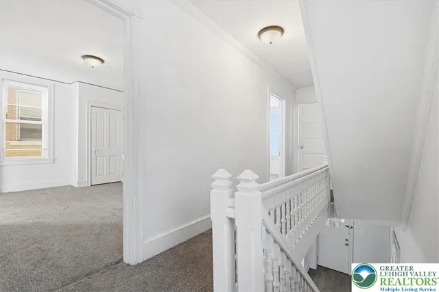 a wooden house covered with snow in front of house