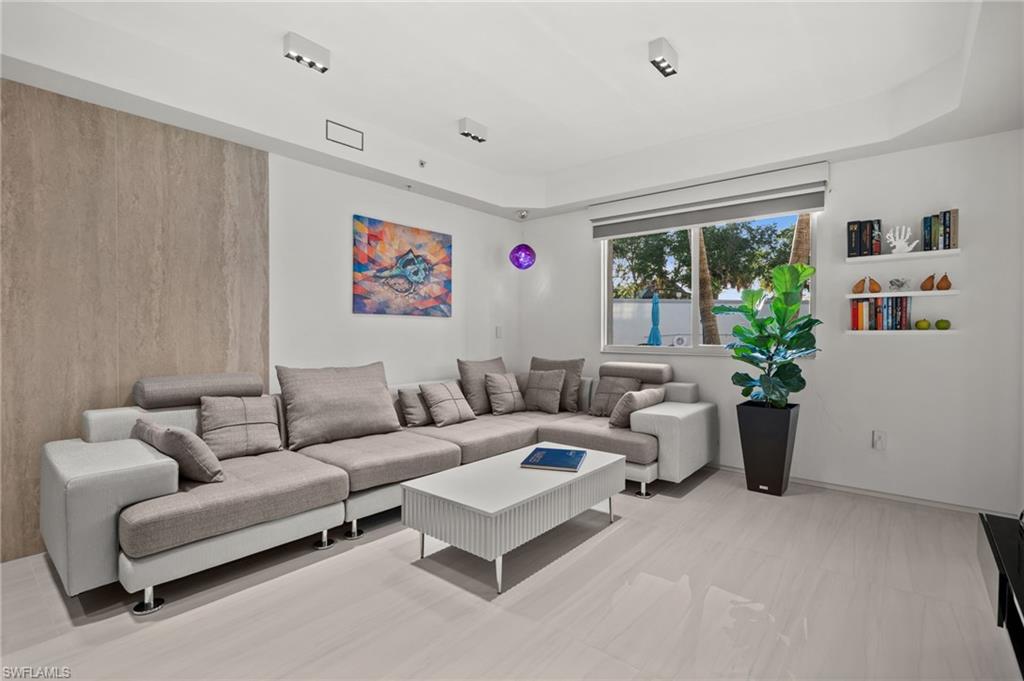 1100 Pine Ridge Road, Unit B103 Naples, FL 34108 - Photo 15 of 38 a living room with furniture and a potted plant
