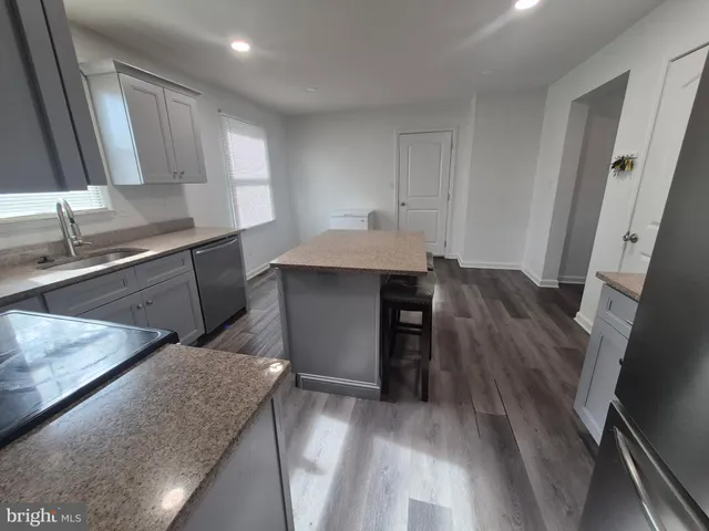 a kitchen with a sink a stove and cabinets
