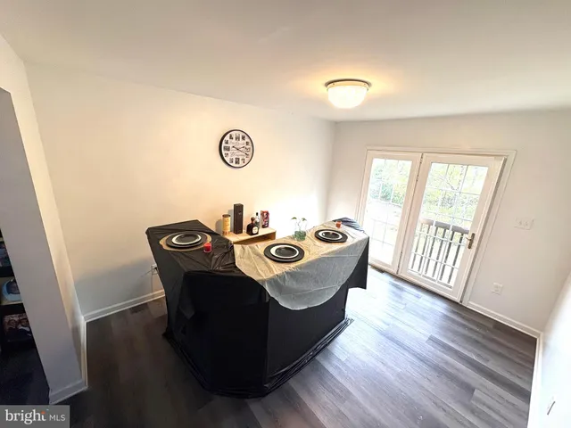 a view of a dining room with furniture wooden floor and a window