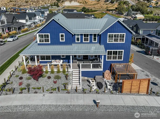 an aerial view of a house with a yard