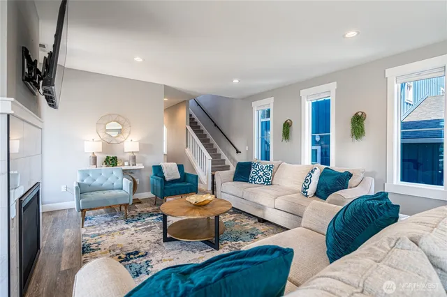 a living room with furniture wooden floor and a flat screen tv