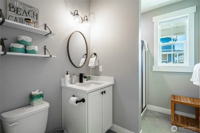 a bathroom with a toilet a sink and a mirror