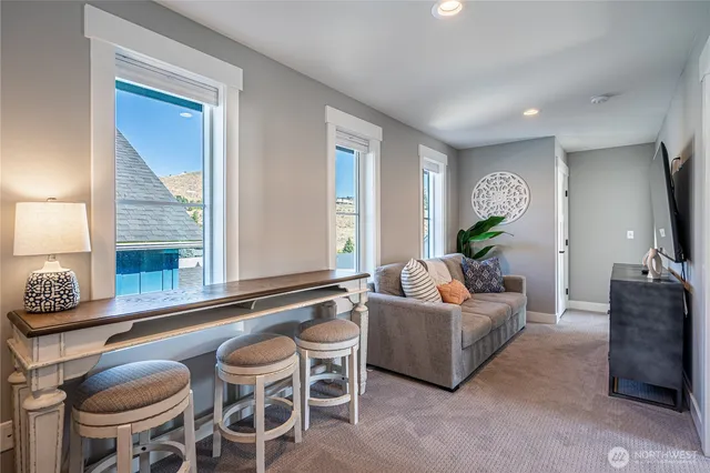 a living room with furniture and a large window