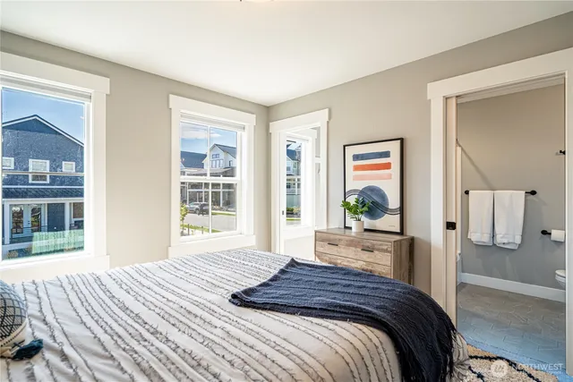 a bedroom with a large bed and a window