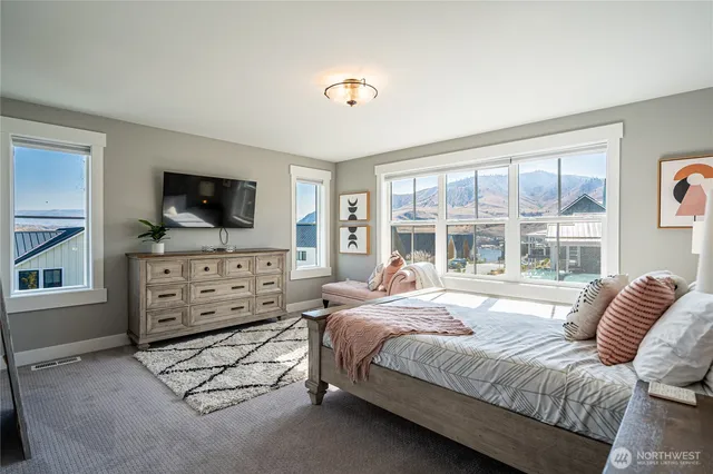 a bedroom with furniture and a flat screen tv