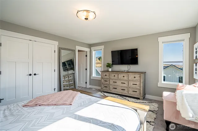 a bedroom with a bed and a flat screen tv