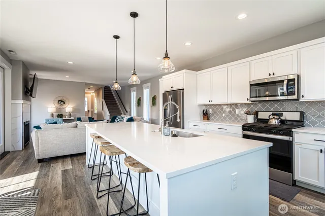 a kitchen with stove a sink and a refrigerator