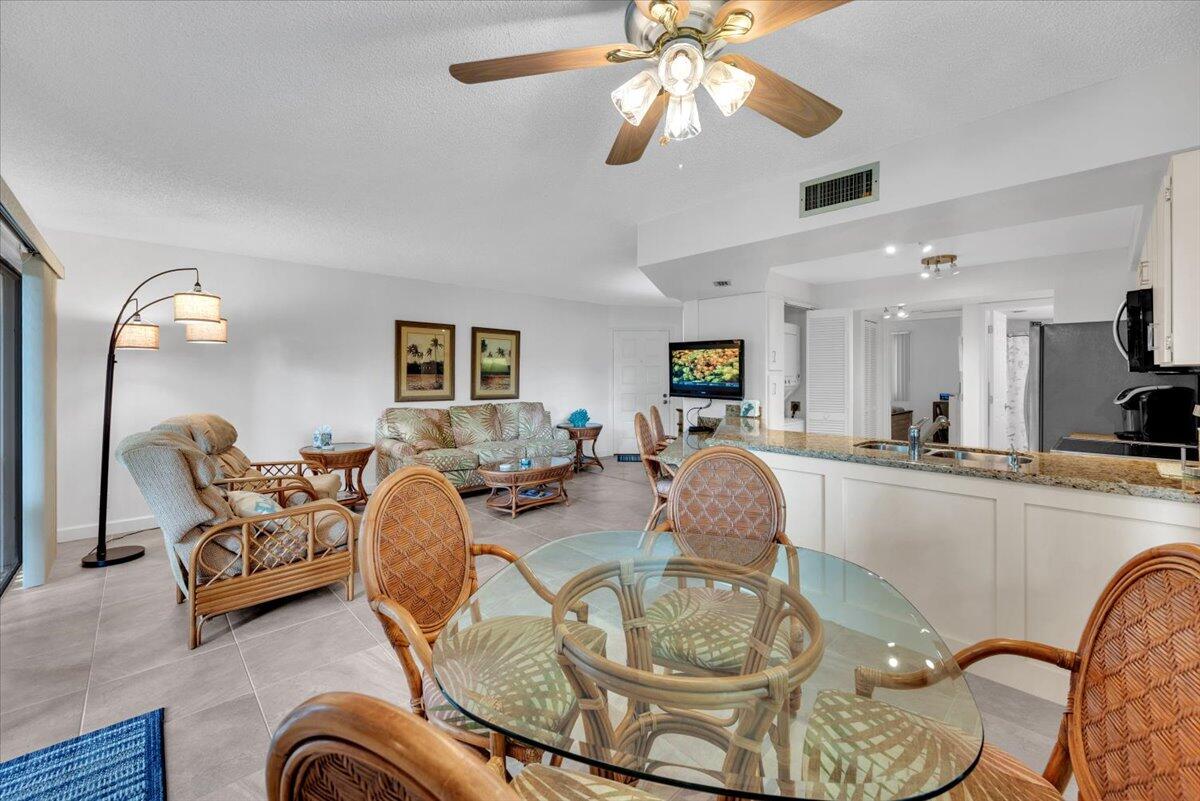 1605 Highway 1, Unit E201 Jupiter, FL 33477 - Photo 12 of 19 a living room with furniture and a chandelier