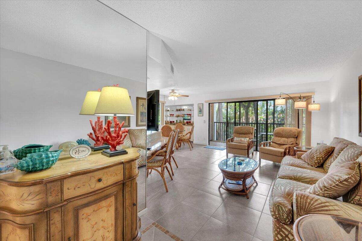 1605 Highway 1, Unit E201 Jupiter, FL 33477 - Photo 6 of 19 a living room with furniture a couch and a potted plant