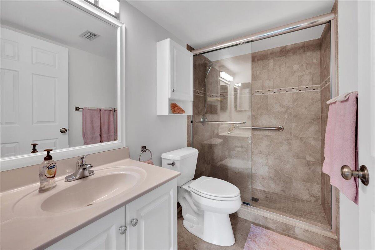 1605 Highway 1, Unit E201 Jupiter, FL 33477 - Photo 10 of 19 a bathroom with a sink toilet and shower