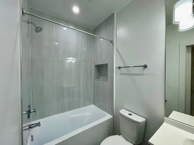 a bathroom with a shower and a toilet