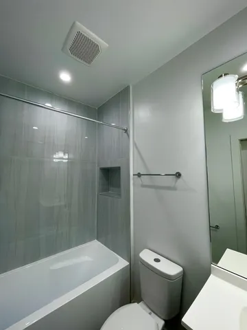 a bathroom with a toilet and a shower