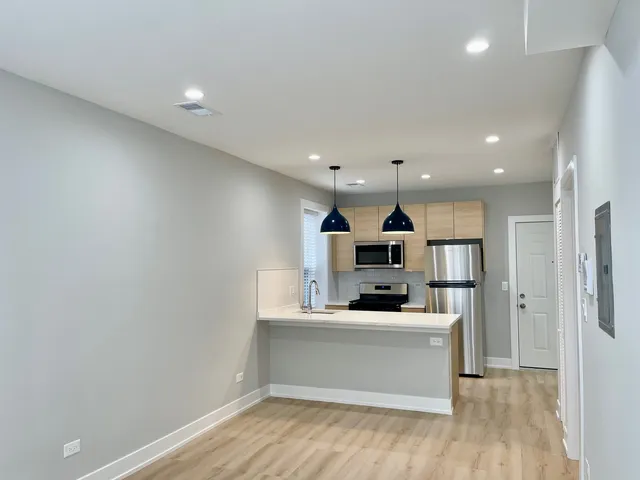 a view of kitchen with refrigerator and window