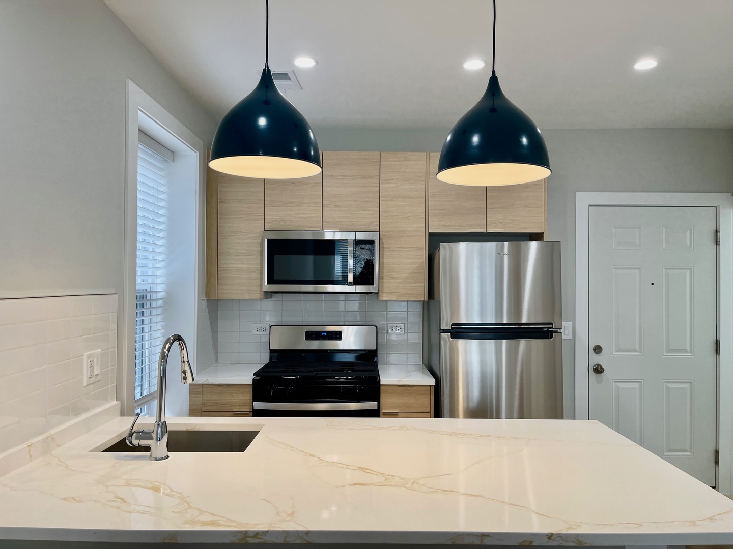 2238 West 24th Street, Unit 1F Chicago, IL 60608 - Photo 5 of 16 a kitchen with stainless steel appliances a stove a sink a refrigerator and cabinets