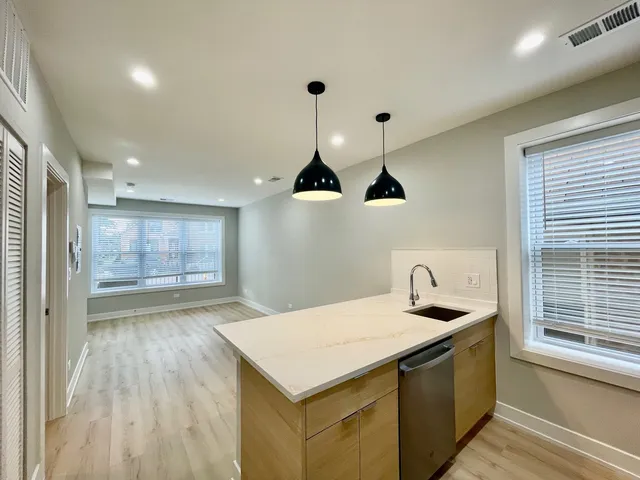 a kitchen with a stove and a wooden floors