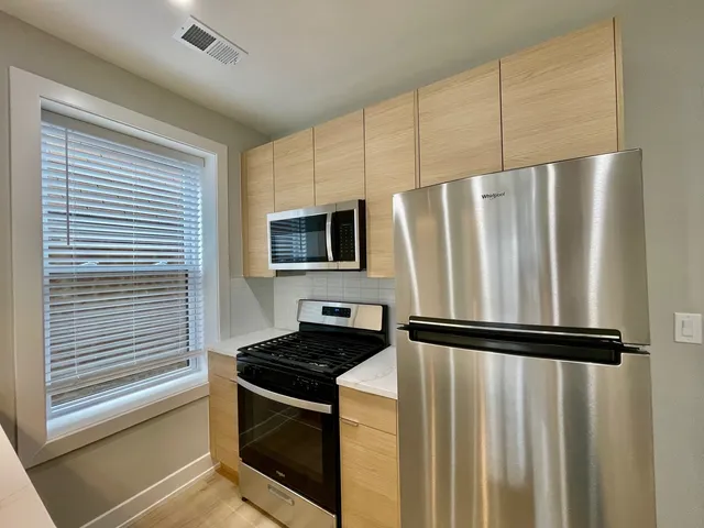 a kitchen with a refrigerator stove and microwave