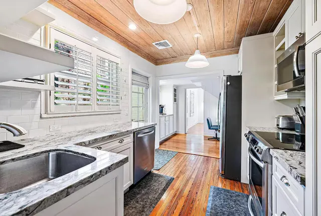 a room with wooden floor and furniture