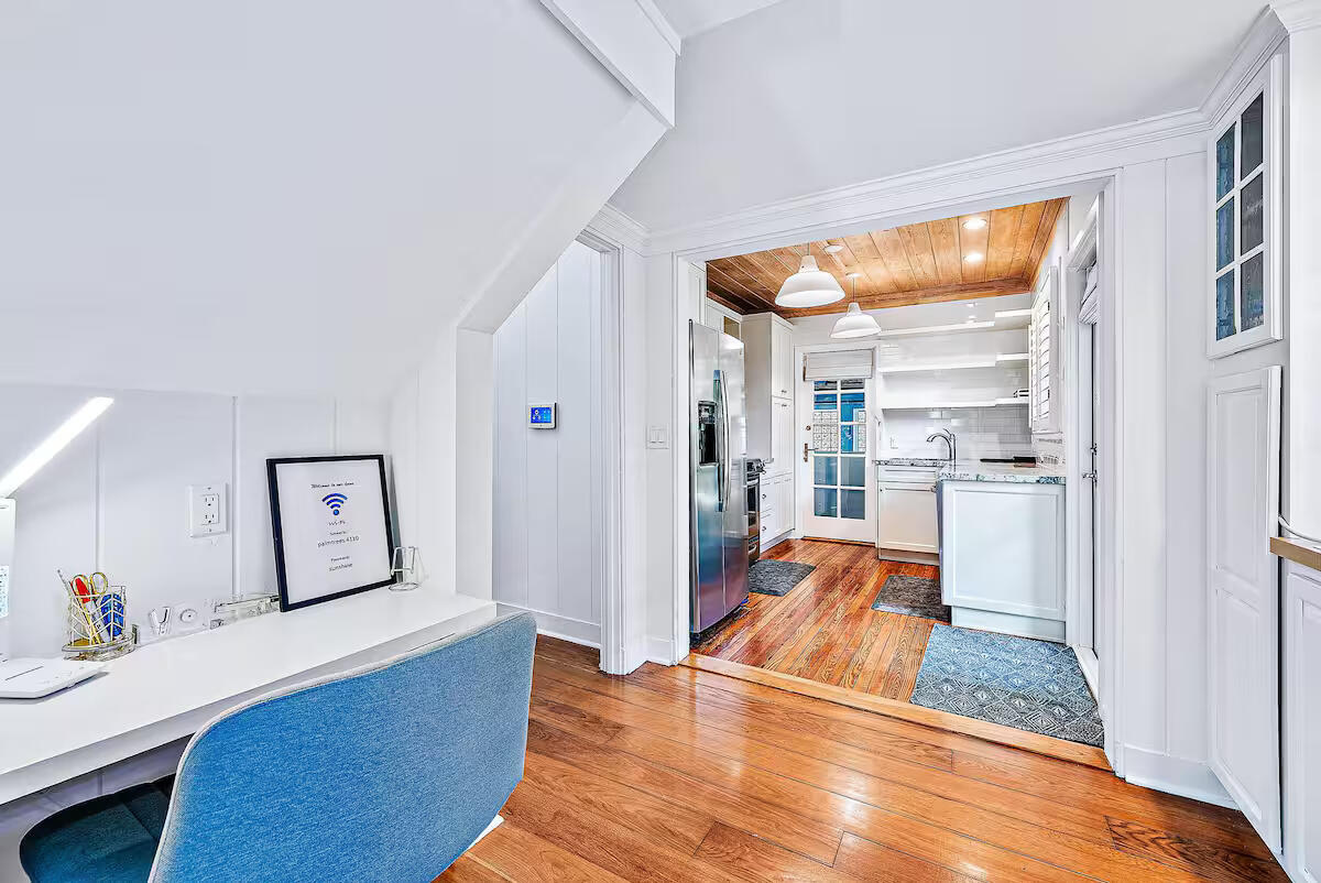 4110 Washington Road West Palm Beach, FL 33405 - Photo 12 of 38 a room with wooden floor and furniture