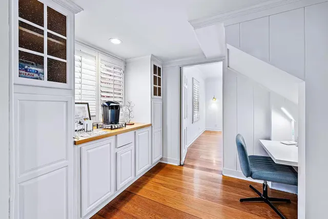 a view of a dining room with furniture and wooden floor