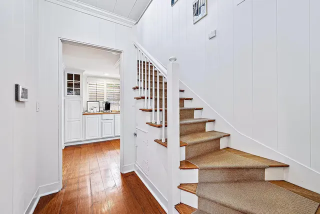 a view of a hallway view with wooden floor and staircase