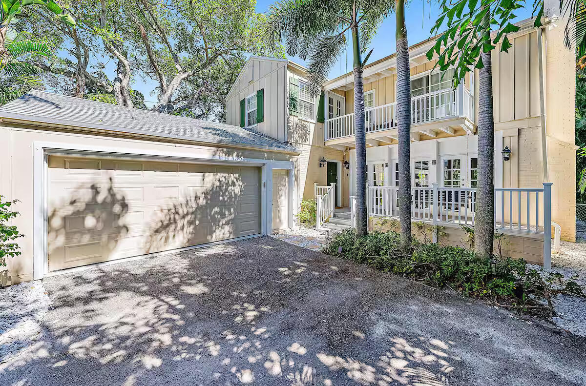 4110 Washington Road West Palm Beach, FL 33405 - Photo 2 of 38 a front view of a house with a garden