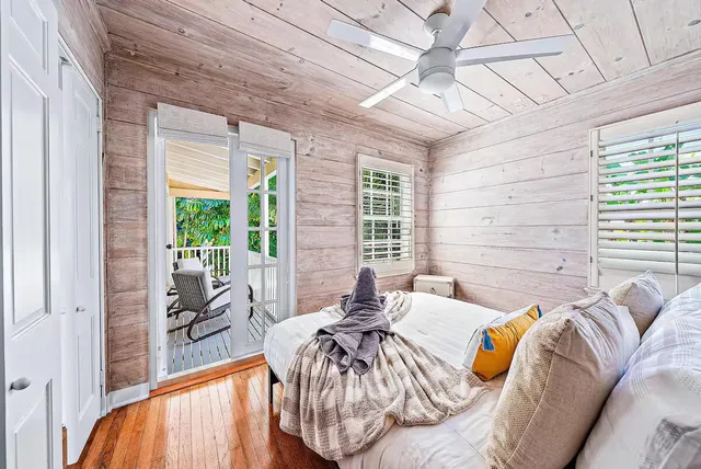 a bed sitting in a bedroom next to a window