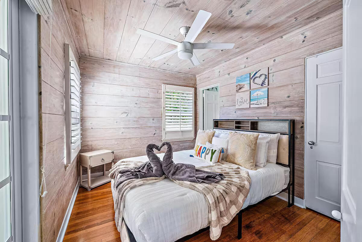 4110 Washington Road West Palm Beach, FL 33405 - Photo 25 of 38 a bed sitting in a bedroom next to a window