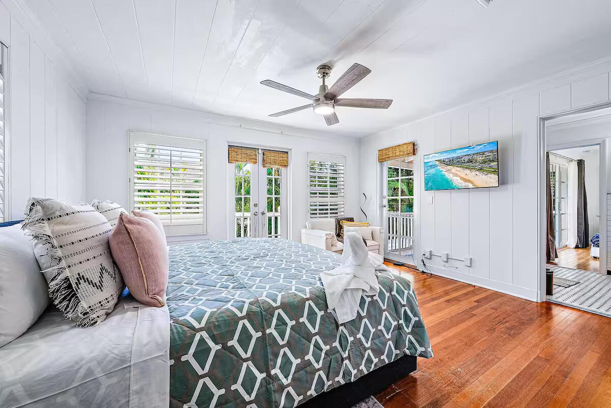 4110 Washington Road West Palm Beach, FL 33405 - Photo 27 of 38 a bed sitting in a bedroom next to a window