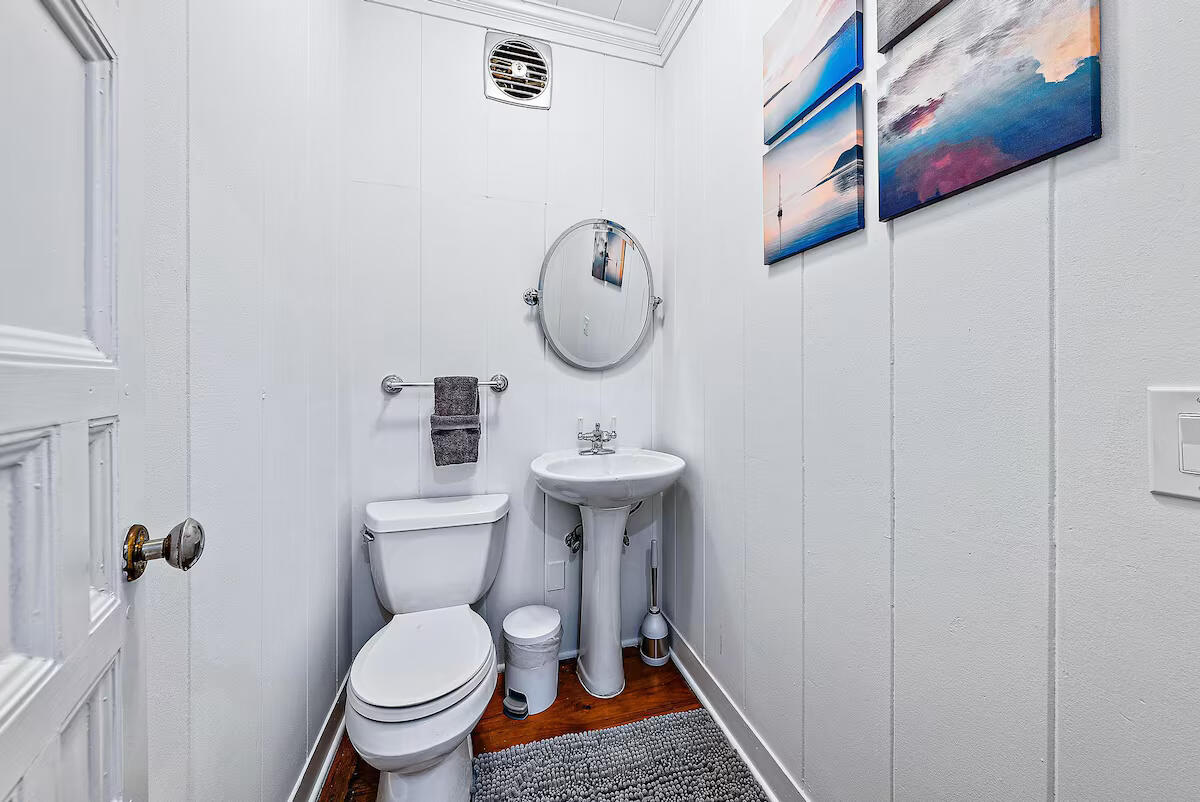 4110 Washington Road West Palm Beach, FL 33405 - Photo 28 of 38 a bathroom with a toilet a sink and a mirror