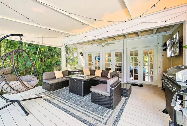 a view of a patio with table and chairs and potted plants