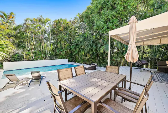 an aerial view of a house with garden space and street view
