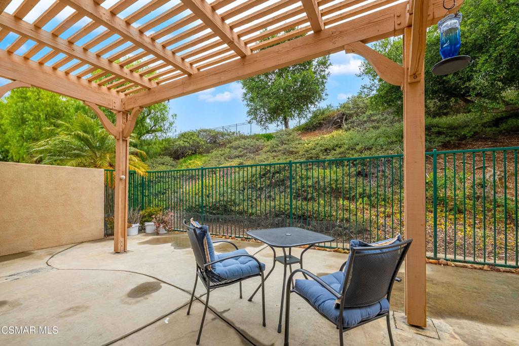 580 Fenwick Way, Unit C Simi Valley, CA 93065 - Photo 15 of 39 a patio with glass top table and chairs