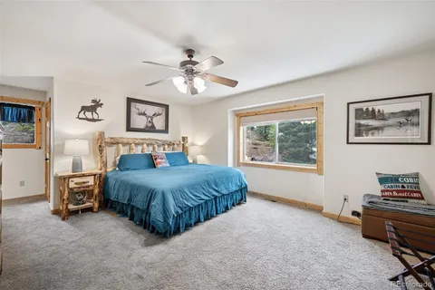 a bedroom with a bed dresser and a window