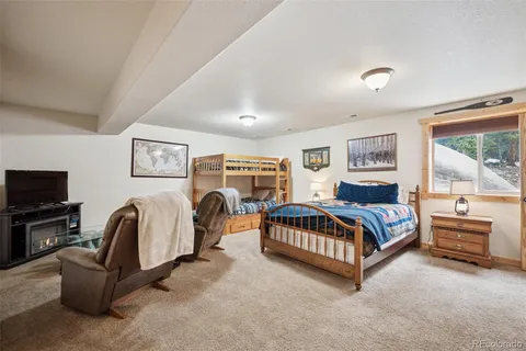 a bedroom with furniture and a flat screen tv